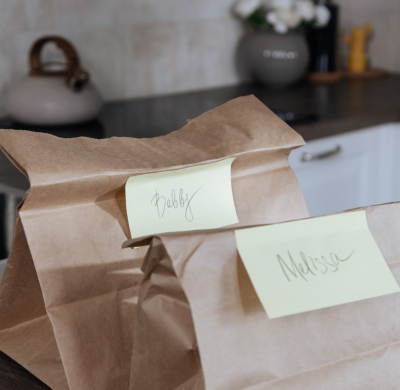 Two bagged lunches sitting on a counter. The Day center provides cold lunches to people who are homeless.